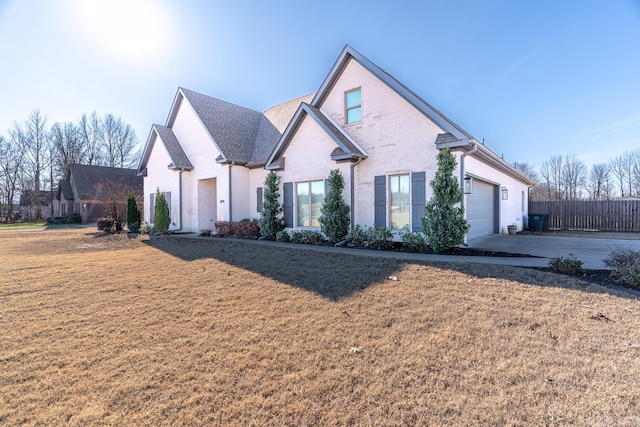 view of front facade with a front yard and a garage