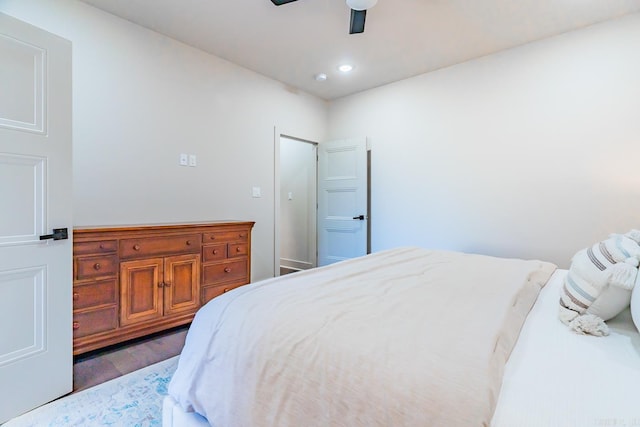 bedroom with dark hardwood / wood-style floors and ceiling fan