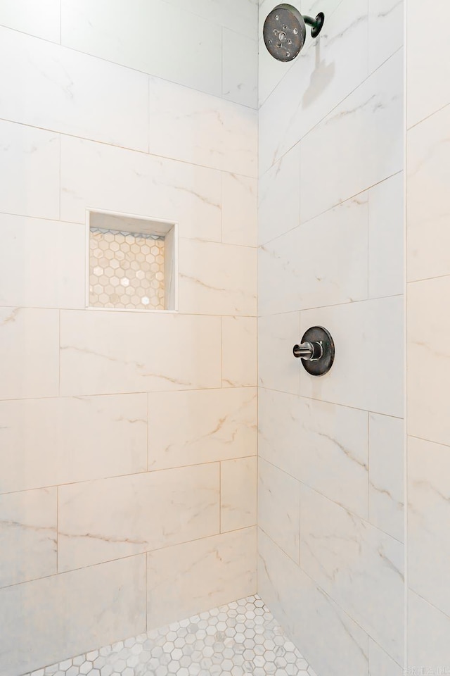 bathroom with tiled shower