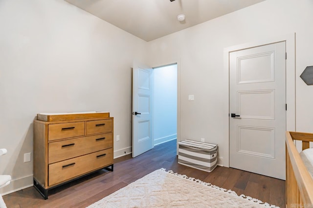 bedroom with dark hardwood / wood-style flooring