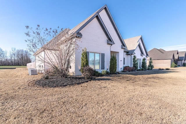 exterior space with cooling unit and a front yard