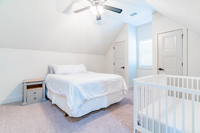 carpeted bedroom with ceiling fan and lofted ceiling