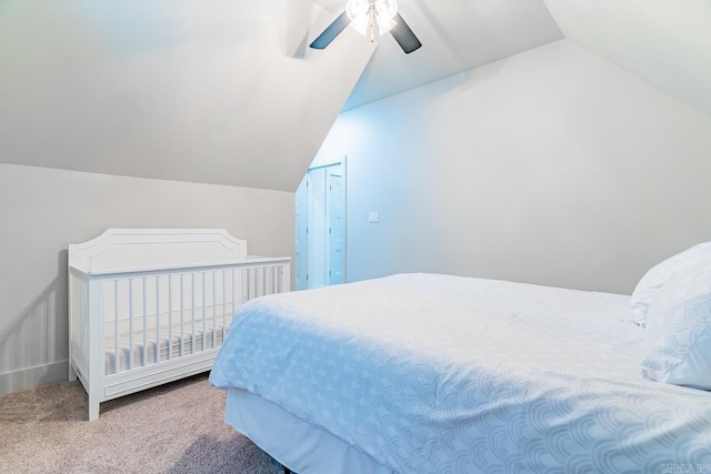 bedroom with ceiling fan, carpet floors, and vaulted ceiling