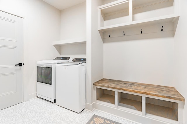 clothes washing area featuring washing machine and dryer and light tile patterned flooring