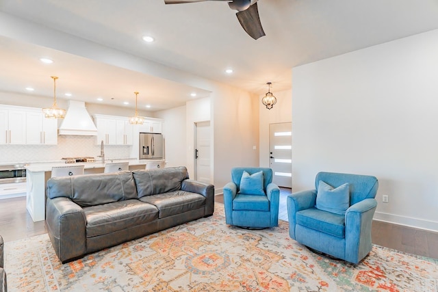 living room featuring light hardwood / wood-style floors and ceiling fan