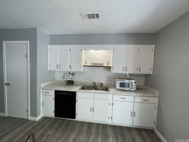 kitchen featuring dark wood-type flooring, sink, decorative backsplash, black dishwasher, and white cabinetry