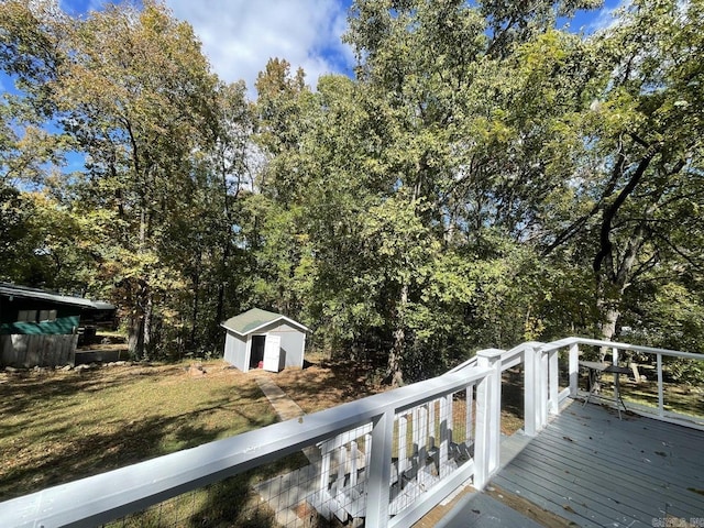 wooden deck with a storage unit and a yard