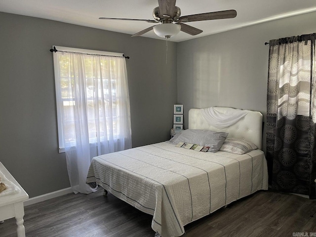 bedroom with ceiling fan and dark wood-type flooring