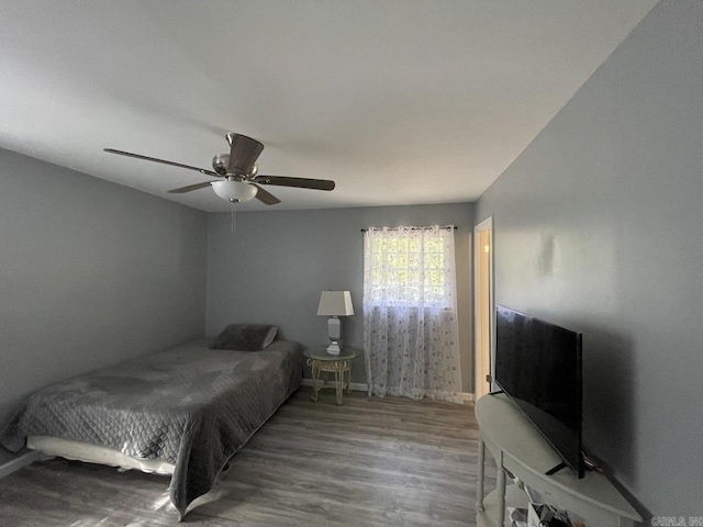 bedroom with hardwood / wood-style floors and ceiling fan