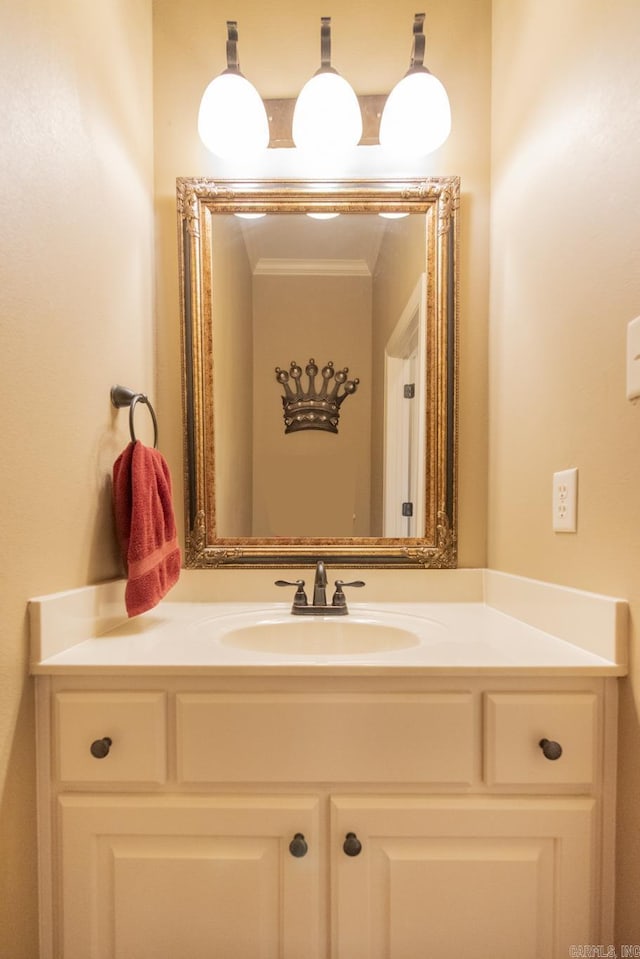 bathroom with vanity and ornamental molding