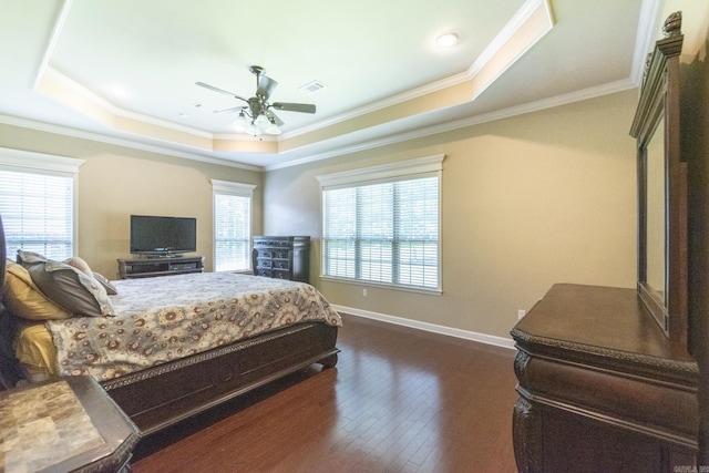 bedroom with dark hardwood / wood-style flooring, a raised ceiling, ceiling fan, and crown molding