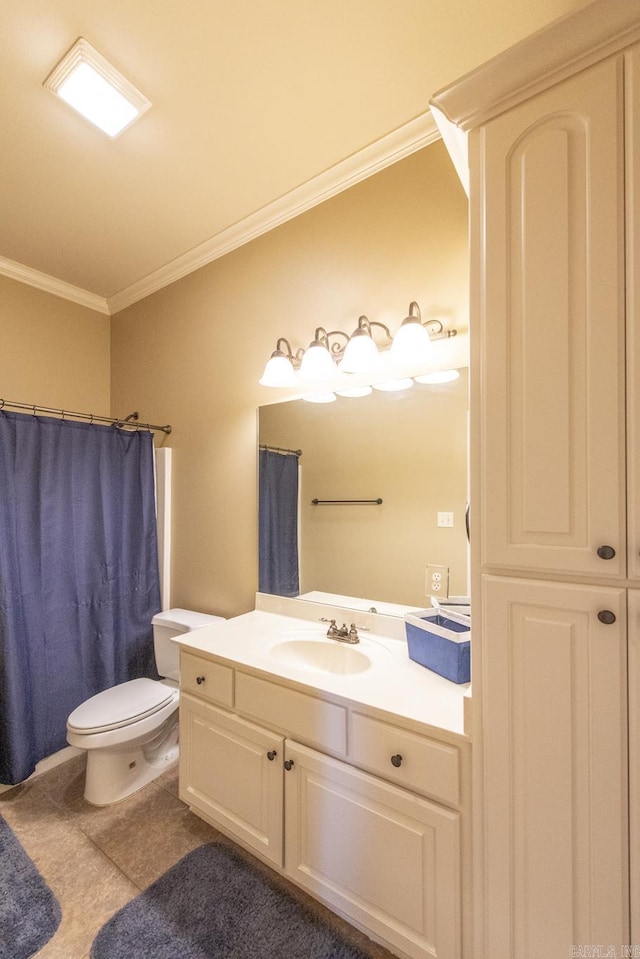 bathroom with toilet, vanity, tile patterned floors, and crown molding