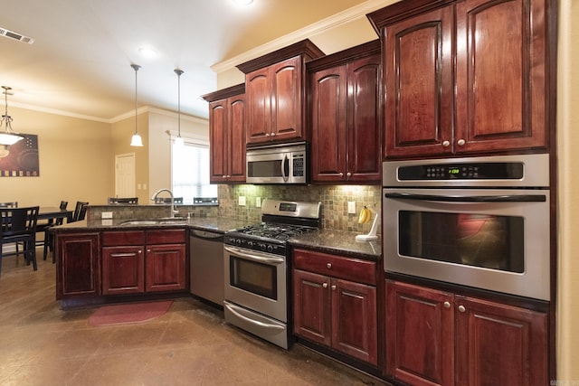 kitchen featuring pendant lighting, dark stone countertops, sink, and appliances with stainless steel finishes