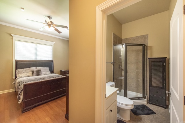 bathroom featuring a shower with door, vanity, wood-type flooring, and toilet