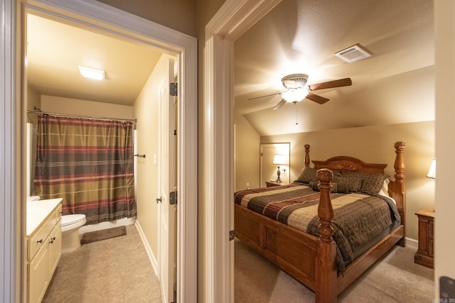 bedroom featuring ceiling fan, lofted ceiling, and light carpet