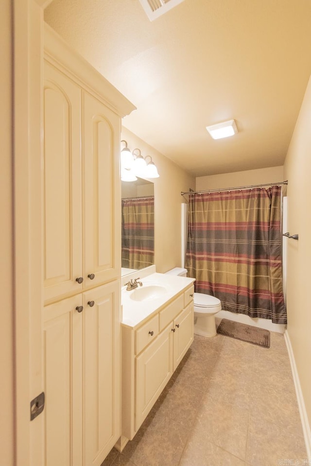 bathroom featuring vanity, toilet, and walk in shower