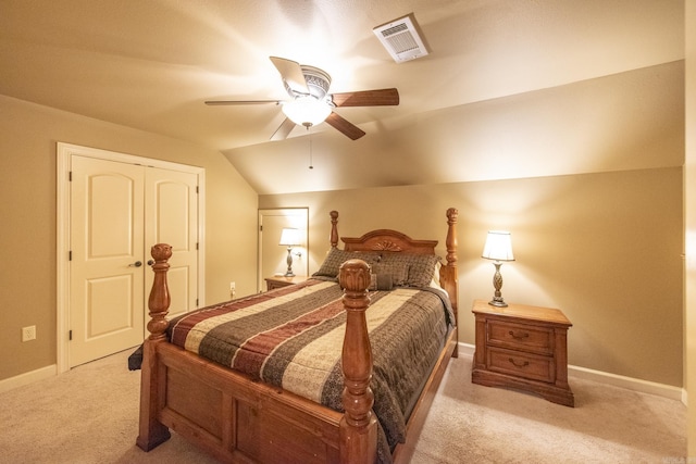 bedroom with light carpet, a closet, ceiling fan, and lofted ceiling