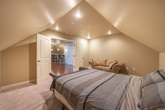 bedroom with light carpet and lofted ceiling