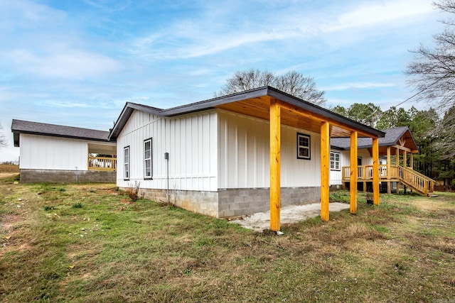 view of property exterior featuring a yard and a wooden deck