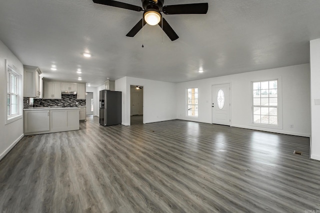 unfurnished living room with hardwood / wood-style floors and ceiling fan