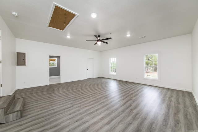 unfurnished room featuring hardwood / wood-style floors, ceiling fan, and electric panel