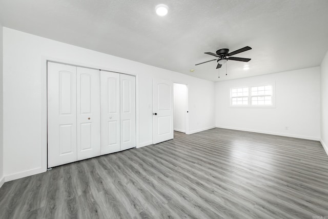 unfurnished bedroom with ceiling fan, light hardwood / wood-style floors, and a textured ceiling