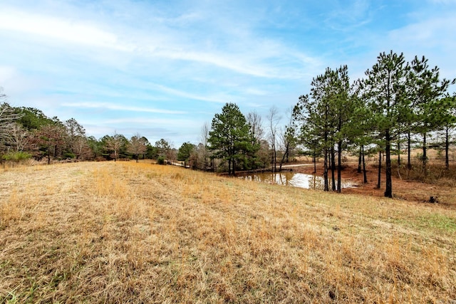 view of yard featuring a rural view and a water view