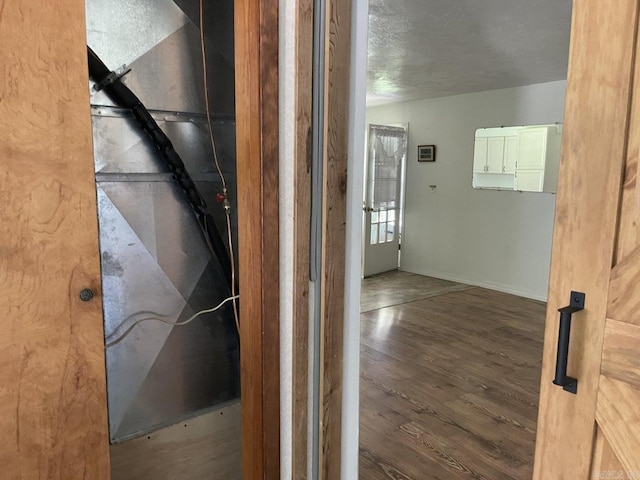 interior space with dark hardwood / wood-style flooring and a textured ceiling