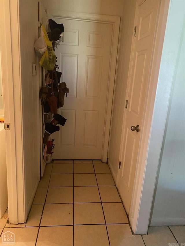 hall featuring light tile patterned floors