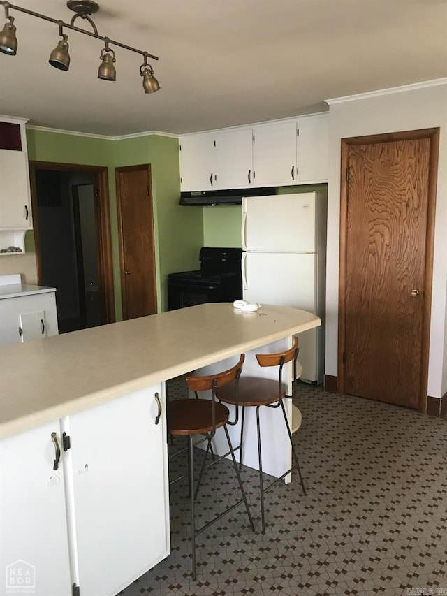 kitchen with a breakfast bar, crown molding, white cabinets, white fridge, and black range with electric stovetop