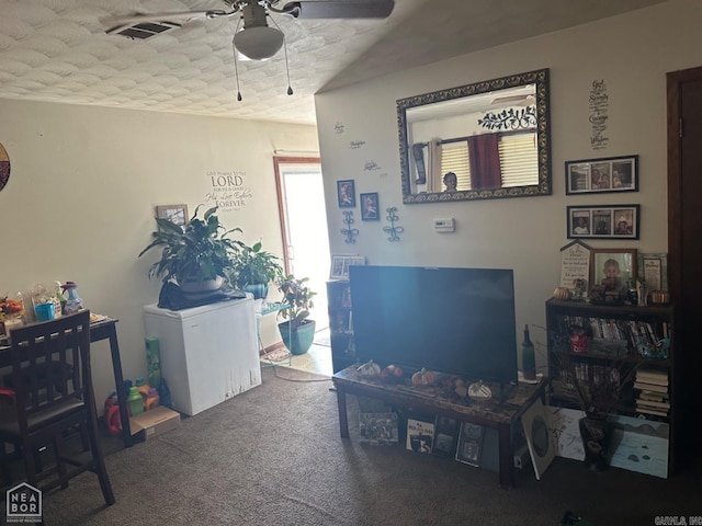 interior space with carpet flooring, ceiling fan, and a textured ceiling