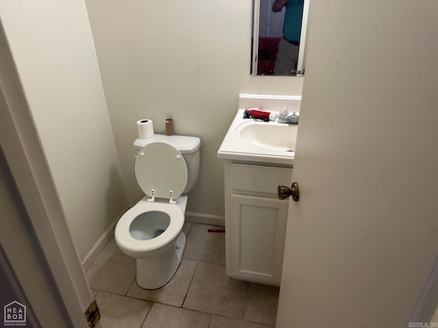 bathroom featuring toilet, vanity, and tile patterned floors