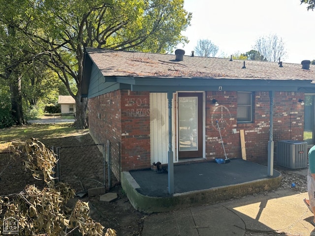 back of house with central air condition unit and a patio area