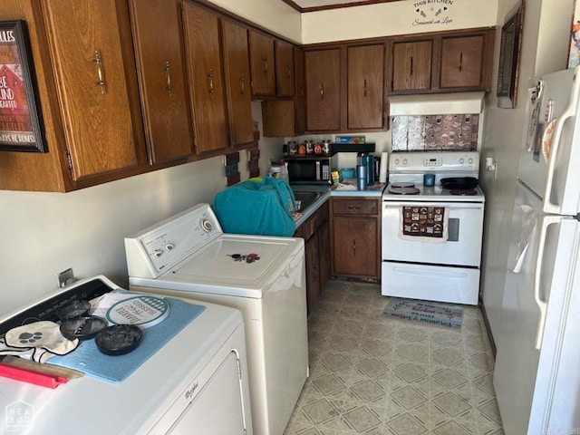 kitchen with washer and dryer and white appliances