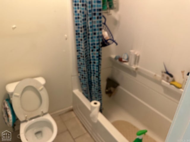 bathroom with tile patterned flooring, toilet, and shower / tub combo with curtain