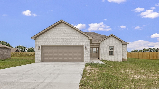 view of front of property with a garage and a front yard