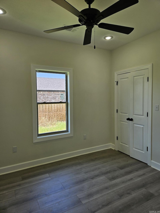 unfurnished room featuring dark hardwood / wood-style floors and ceiling fan