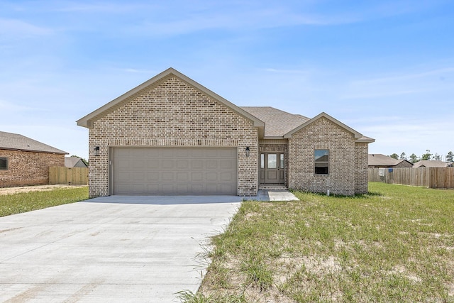 view of front of home featuring a front yard and a garage