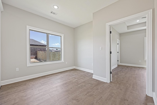 spare room featuring light hardwood / wood-style flooring