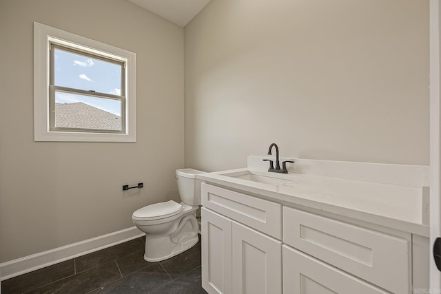 bathroom featuring tile patterned flooring, vanity, and toilet