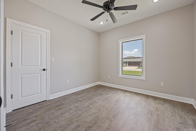 empty room with light hardwood / wood-style flooring and ceiling fan