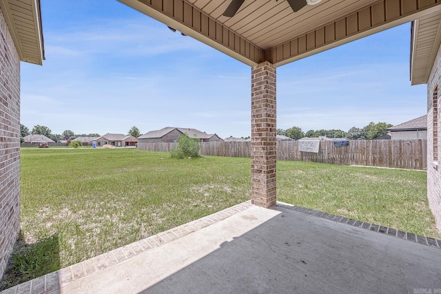 view of yard with a patio area and ceiling fan