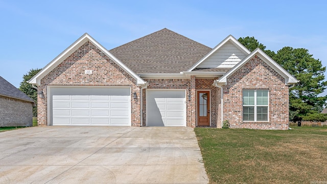 view of front of home featuring a garage and a front lawn