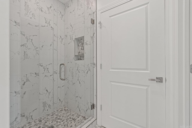 bathroom featuring a shower with door