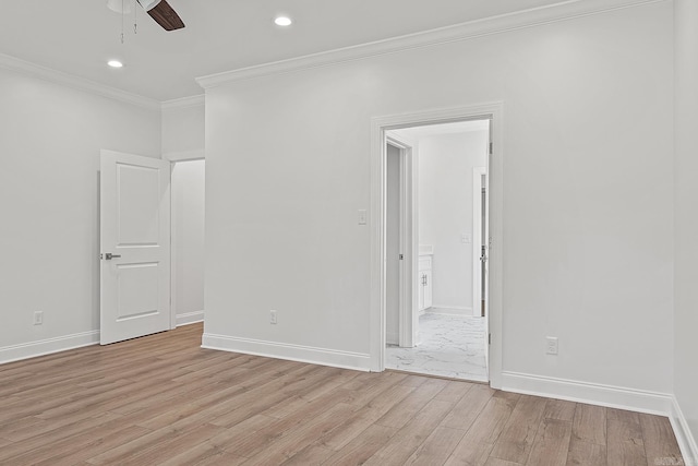 empty room featuring ceiling fan, light wood-type flooring, and ornamental molding