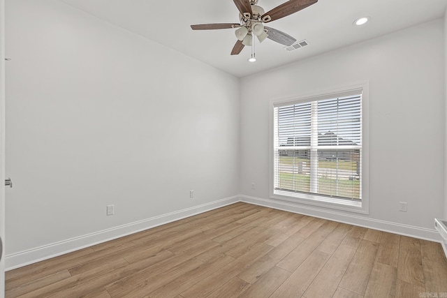 empty room with ceiling fan and light wood-type flooring