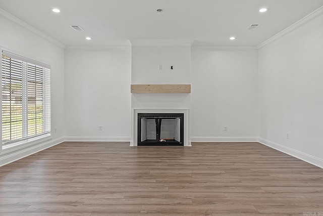 unfurnished living room featuring light wood-type flooring and ornamental molding