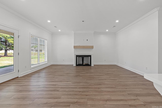 unfurnished living room with light wood-type flooring and ornamental molding