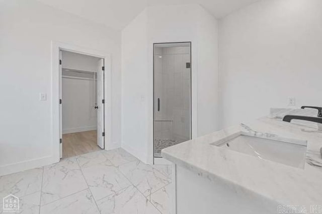 bathroom featuring vanity and a shower with shower door