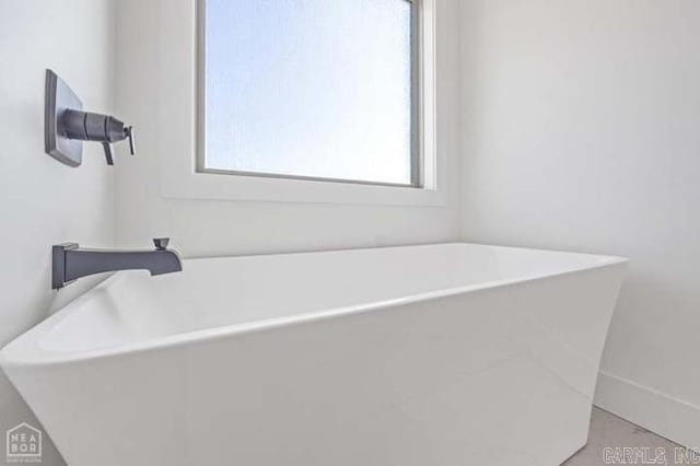 bathroom featuring plenty of natural light and a bathing tub